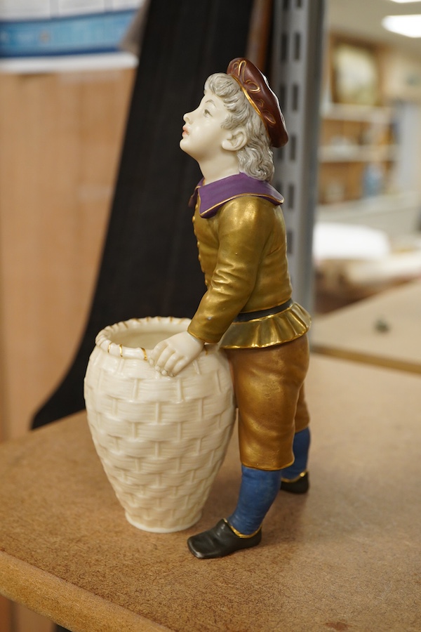 A late 19th century Royal Worcester figure of a boy with basket, 17.5cm high